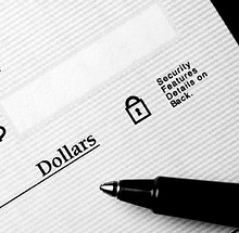 Pen on blank check to be written with dollars.jpg