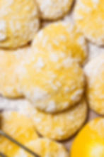 Rustic classic lemon crinkle cookies on a parchment paper background