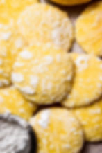 Rustic classic lemon crinkle cookies on a parchment paper background