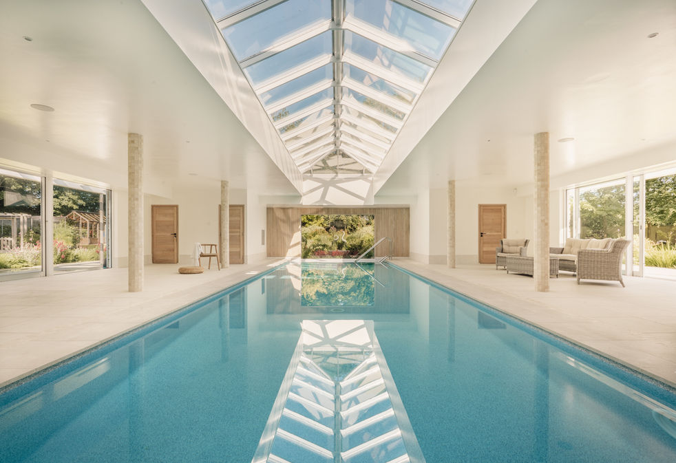 Luxury swimming pool in a residential home with glass roof designed by Novaco design in Dorset, interior photography by Sarah Middleton