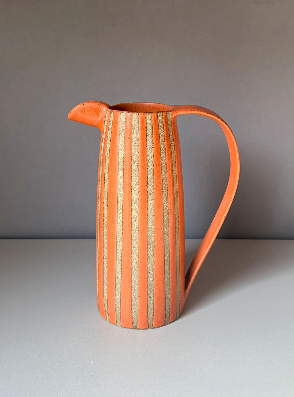 Thumbnail: Stoneware jug with orange glaze