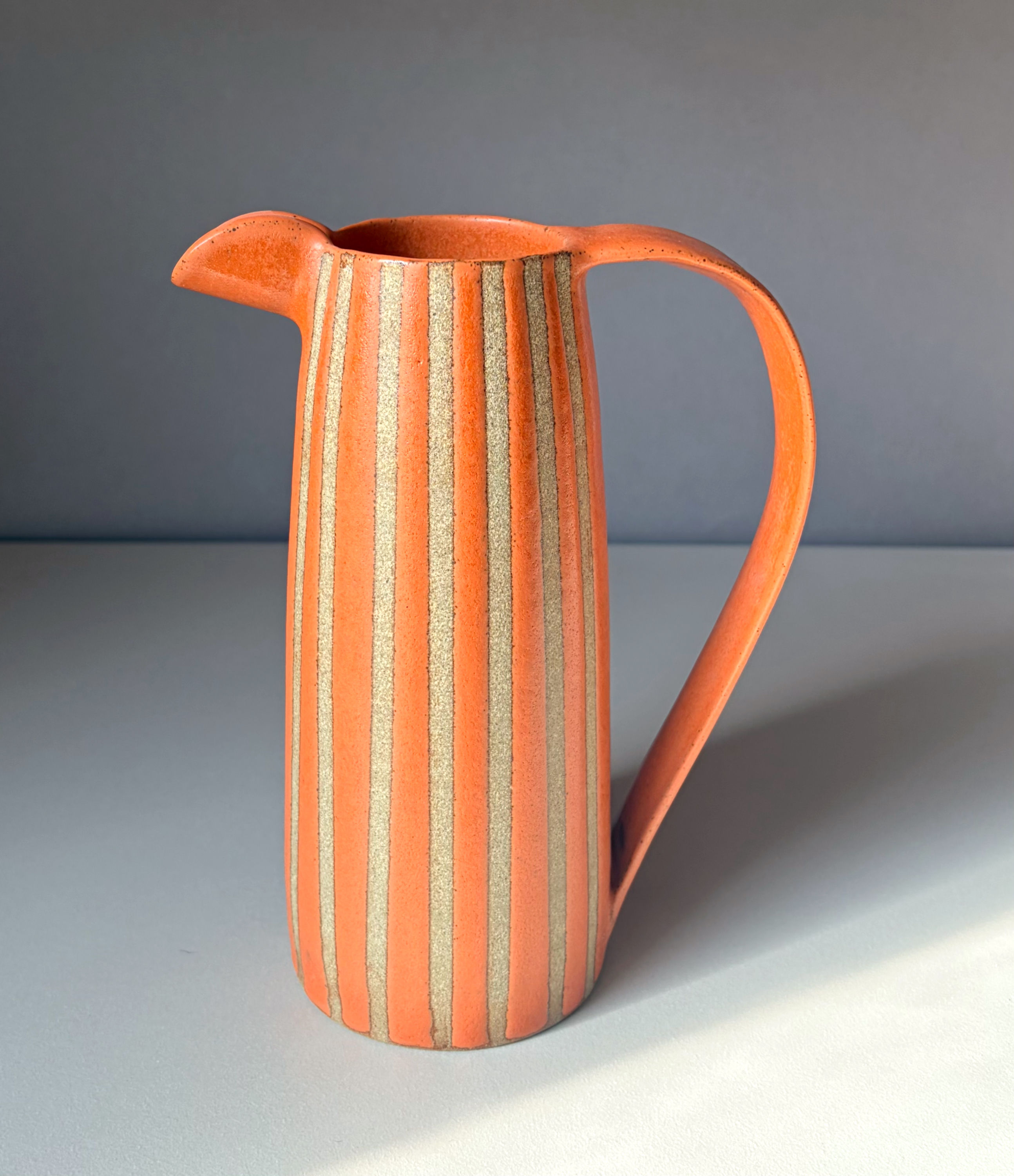 Stoneware jug with orange glaze
