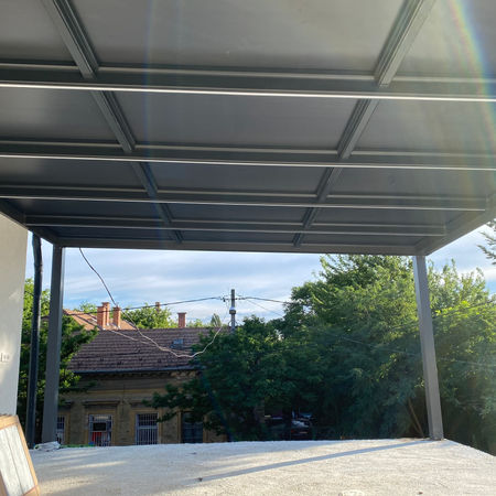 Aluminum pergola with panel roof on modern house terrace