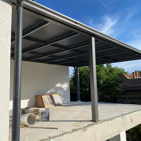 Aluminum pergola with panel roof on modern house terrace