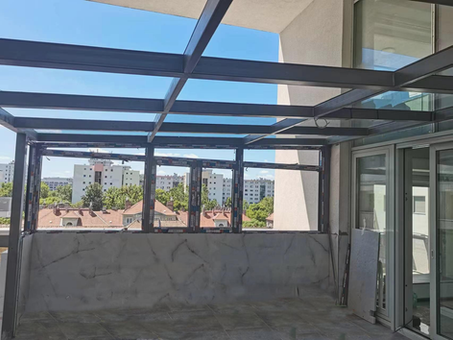 View of a terrace with windows and a cityscape background
