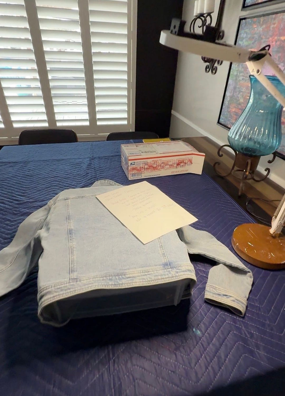 light denim jacket spread out on bed before custom painted denim jacket design