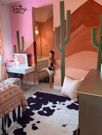 little girls standing in her new room with a diy wall mural