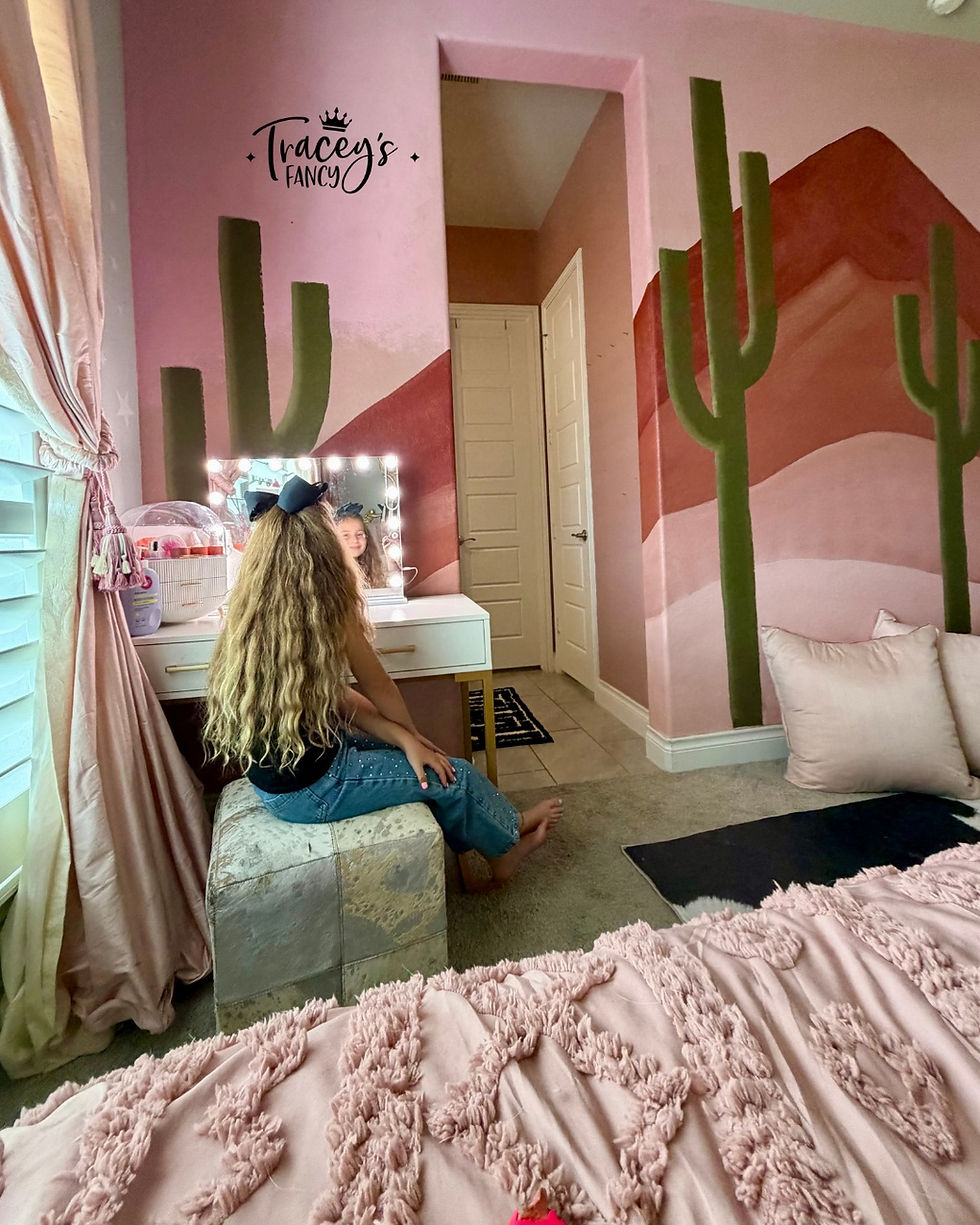 Little girl sitting in front of a vanity admiring her easy DIY Desert Wall Mural by Traceys Fancy