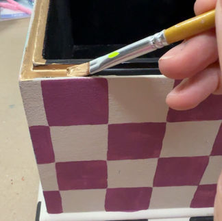 painting gold highlights on whimsical thrifted box