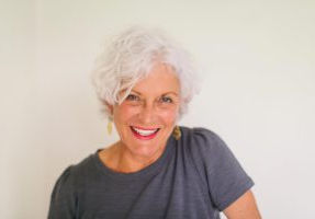 Artist Carylon Ann Cooper laughing as she poses for her portrait that was used in an arts and design magazine