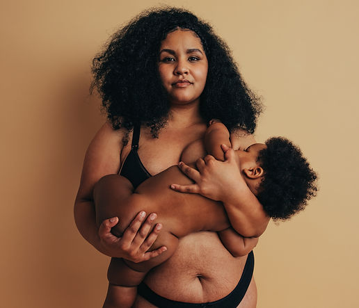 Plus size woman breastfeeding her infant