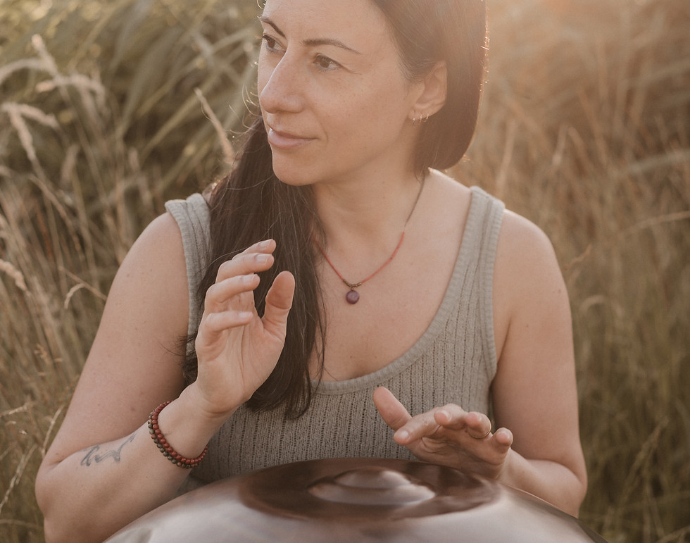 Playing the handpan during a somatic session to create a calm and supportive space.