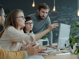 Professionals discussing AI governance and ISO 42001 in a collaborative business setting