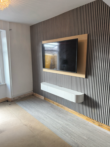 Media wall with slatted panels and floating cabinet in Swansea.