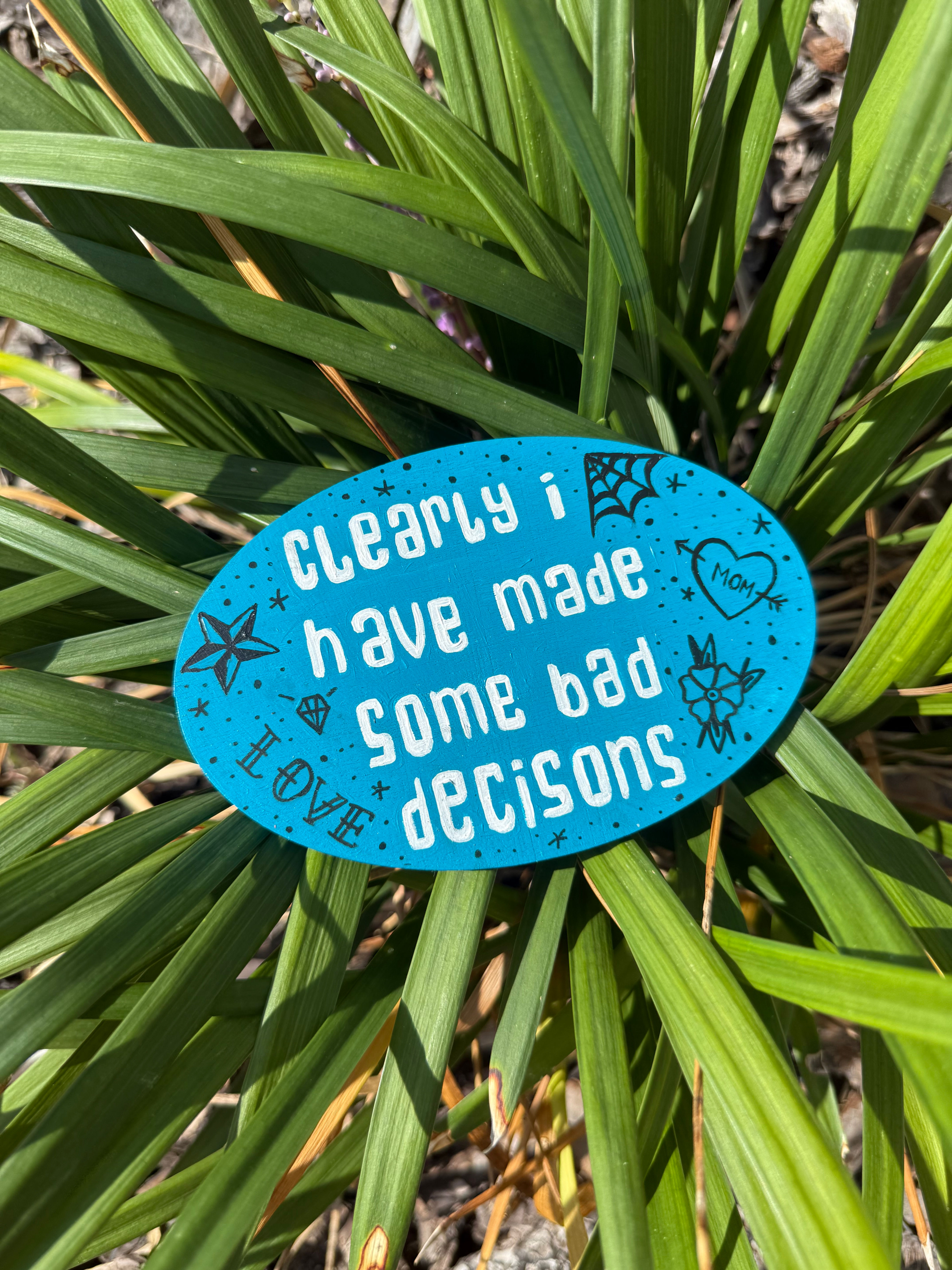 Clearly I Have Made Some Bad Decisions Magnet displayed on a plant
