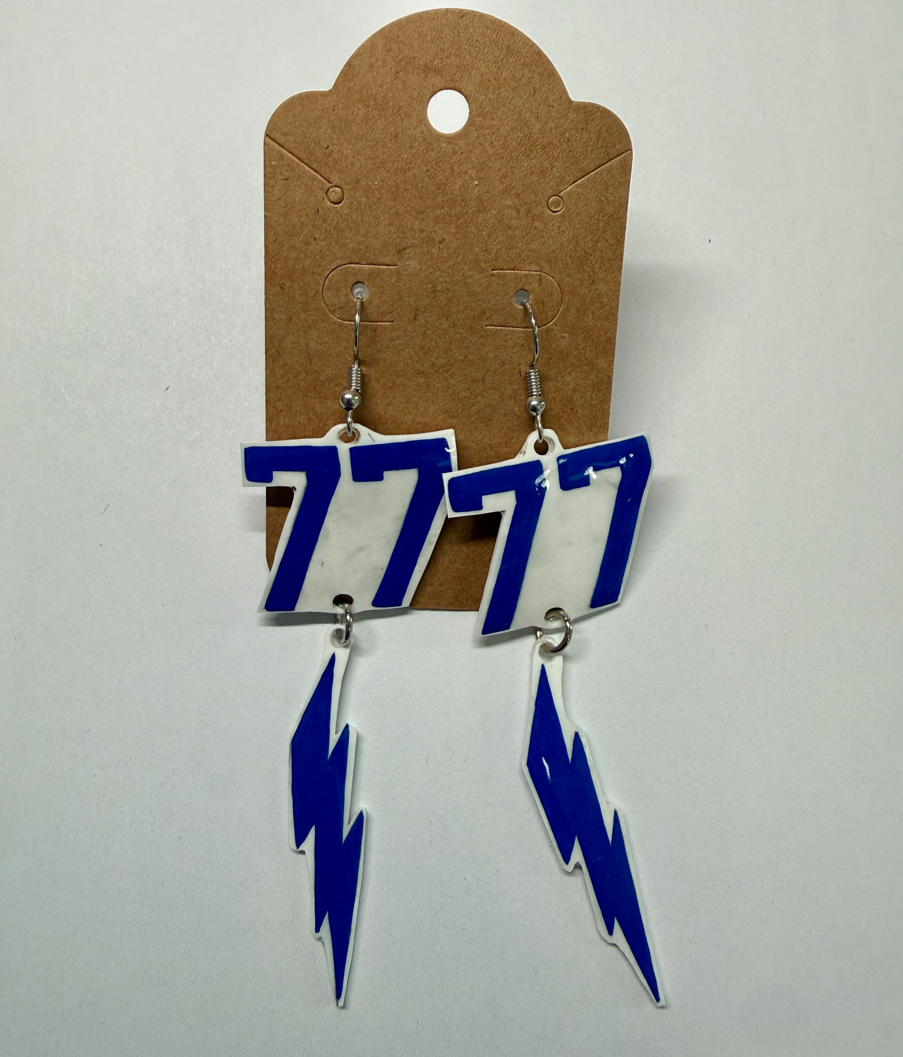 Blue dangly earrings with #77 and a lightning bolt