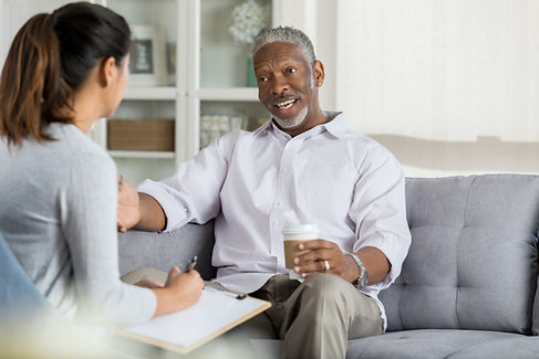 White life insurance professional sitting down with black client discussing 