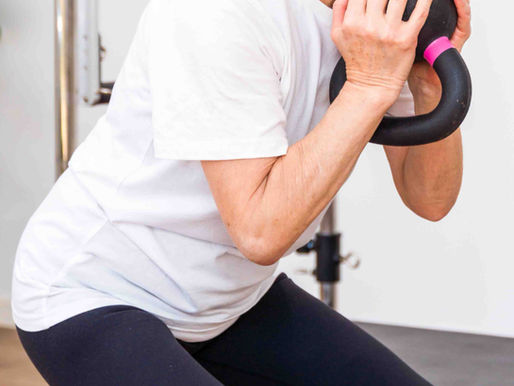 lady doing a pilates squat with kettlebell