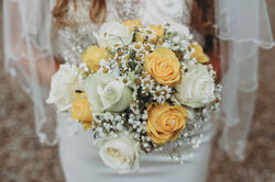 bride-wearing-wedding-dress-holding-her-traditional-bouquet