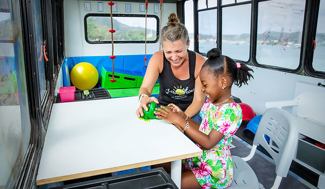Speech therapist providing speech language therapy to a child