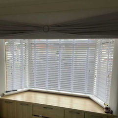 white wooden blinds 