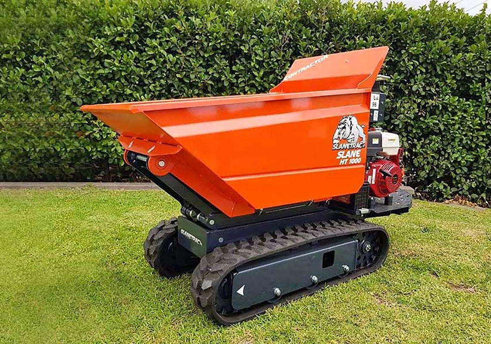 Compact orange dumper positioned beside green hedge on job site