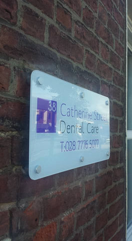White plastic sign mounted to an external wall