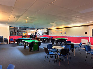 Interior view of East Station Snooker Club showing snooker tables and player seating