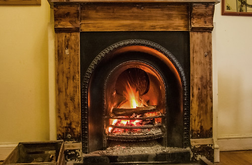 A cast iron fire with a hardwood fireplace