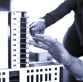 Business people looking at model