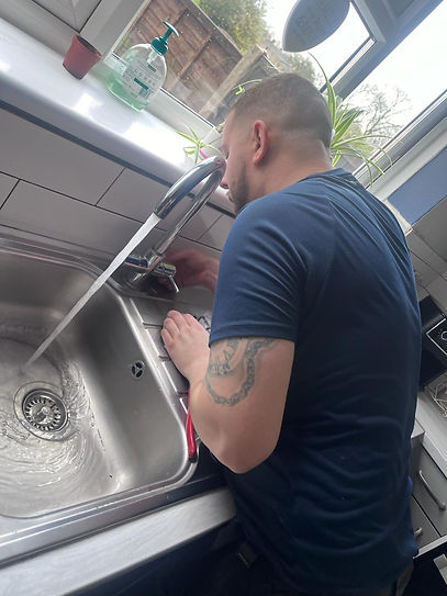 A plumber fixing a kitchen sink