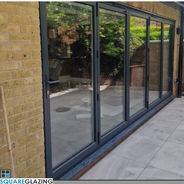 Black modern bifolding door leading to back garden