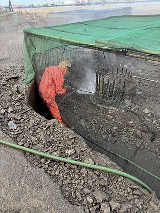 worker water jetting metal poles for surface prep