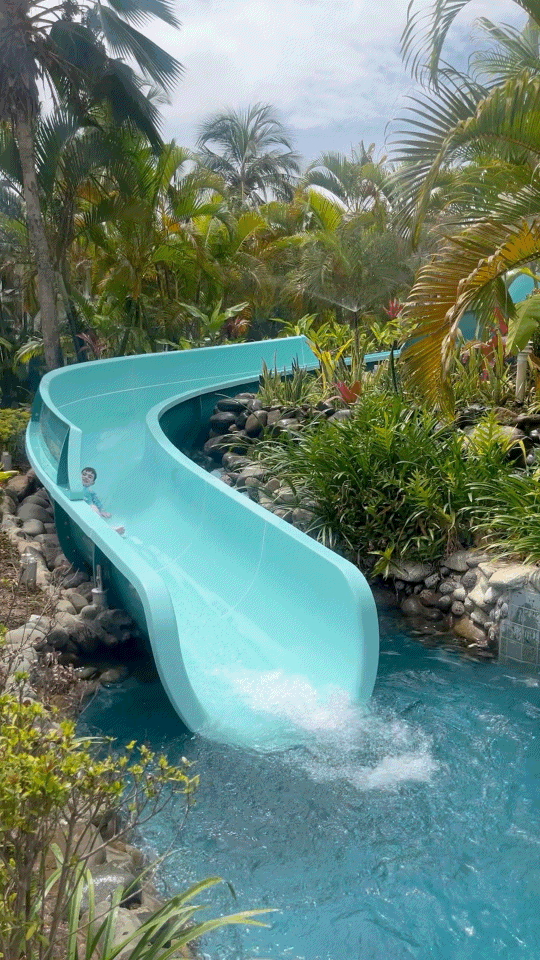 Blue waterslide entering the swimming pool at Sofitel Fiji Resort and Spa on Denarau Island.