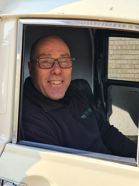 Eric Collins the Classic Car Mechanic sitting in Classic Morris Minor Van