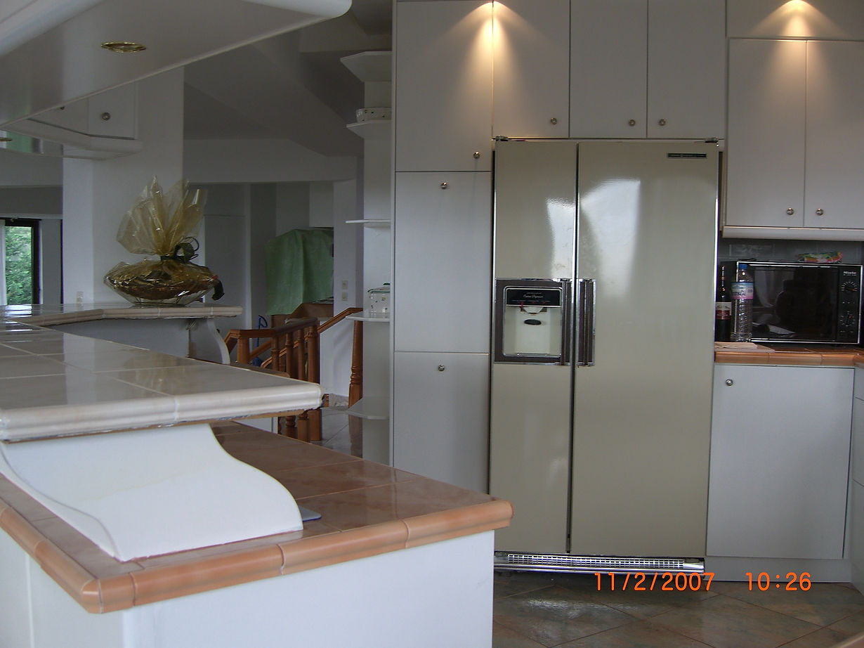 KITCHEN #1. Convieniently designed layout with extra height bar and counter tops, with multiple  upper cabilnets, centrally located facing a see-through fireplace and revolving TV.
