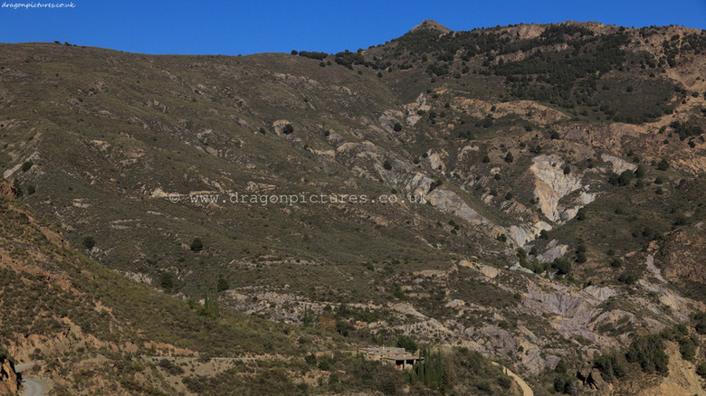 Strategically cropped full-width 16:9 landscape photograph of a spate tributary of El Rio Guadalfeo near its junction with El Rio Trevelez east of Tijola, Las Alpujarras - authentic straight photography with no colour enhancement, ideal for hotel decor.
