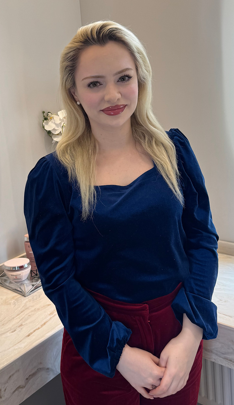 Woman in blue velvet top and burgundy pants