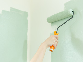 young-woman-self-painted-wall-with-paint-roller_SvWlfbx_3Gg.jpg