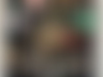 Travel altar setup with crystals, candle, feather, and grounding objects on a mat with a tree symbol