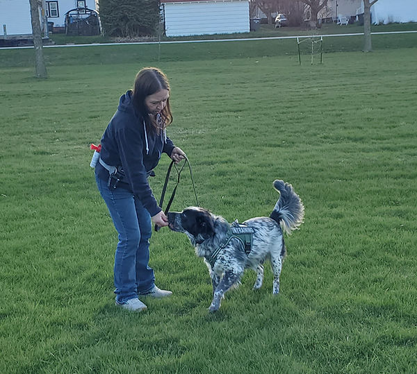 Mecca Curtice rewarding the dog for checking in with her.