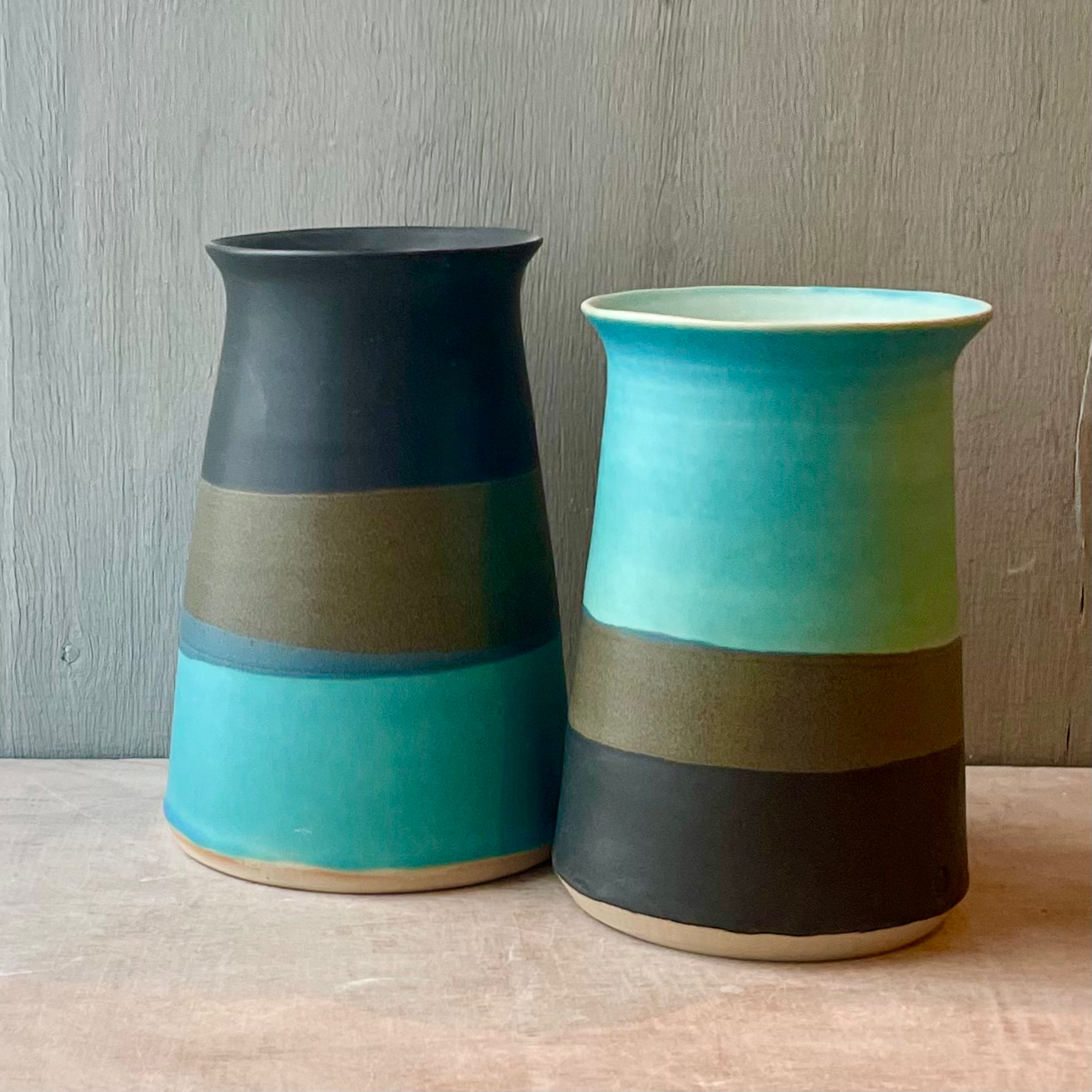 Tall white stoneware vases finished in Stuart Carey’s Black and Egypt Blue glaze