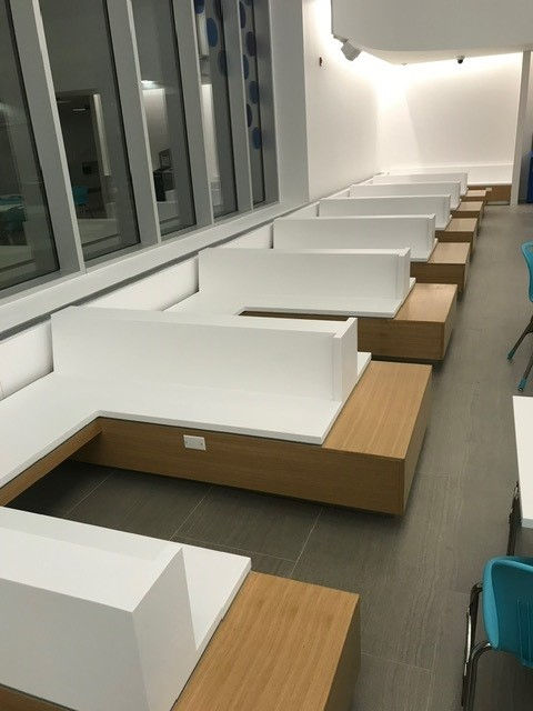 Modern white and wood seating in a commercial food court.