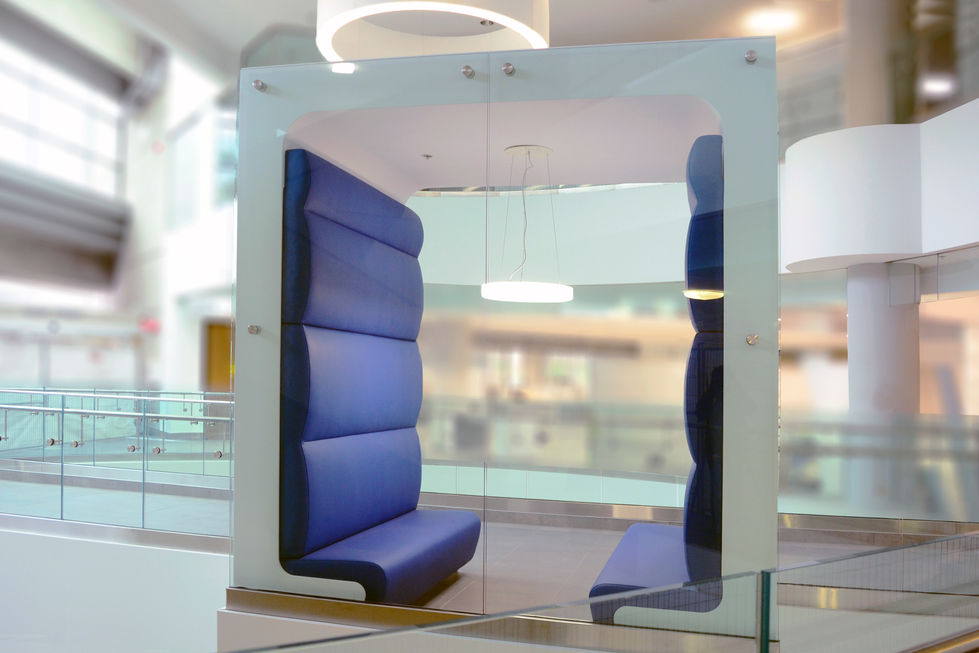 Modern glass seating booth in a commercial food court