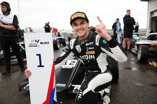 Alex Ninovic shows the number one gesture while celebrating a 1st place podium during the British F4 championship