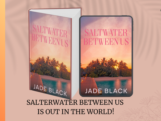 Book and phone displaying "Saltwater Between Us" cover with sunset and palms. Text: "Release Day" and "Saltwater Between Us is out in the world!"