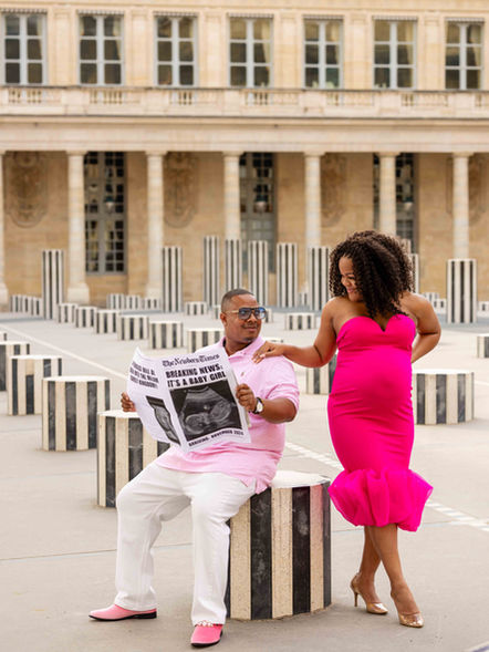 Couple celebrating their baby news during a Paris photoshoot at the Palais Royal