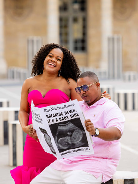 Expecting parents laughing together during a Paris pregnancy announcement photoshoot