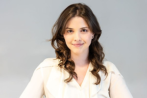 Corporate headshot of a smiling businesswoman, photographed in Paris