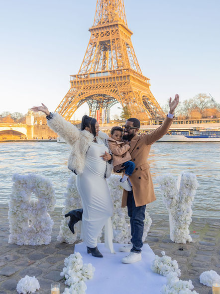 Gender reveal photoshoot in Paris with BABY letters by the Seine and the Eiffel Tower